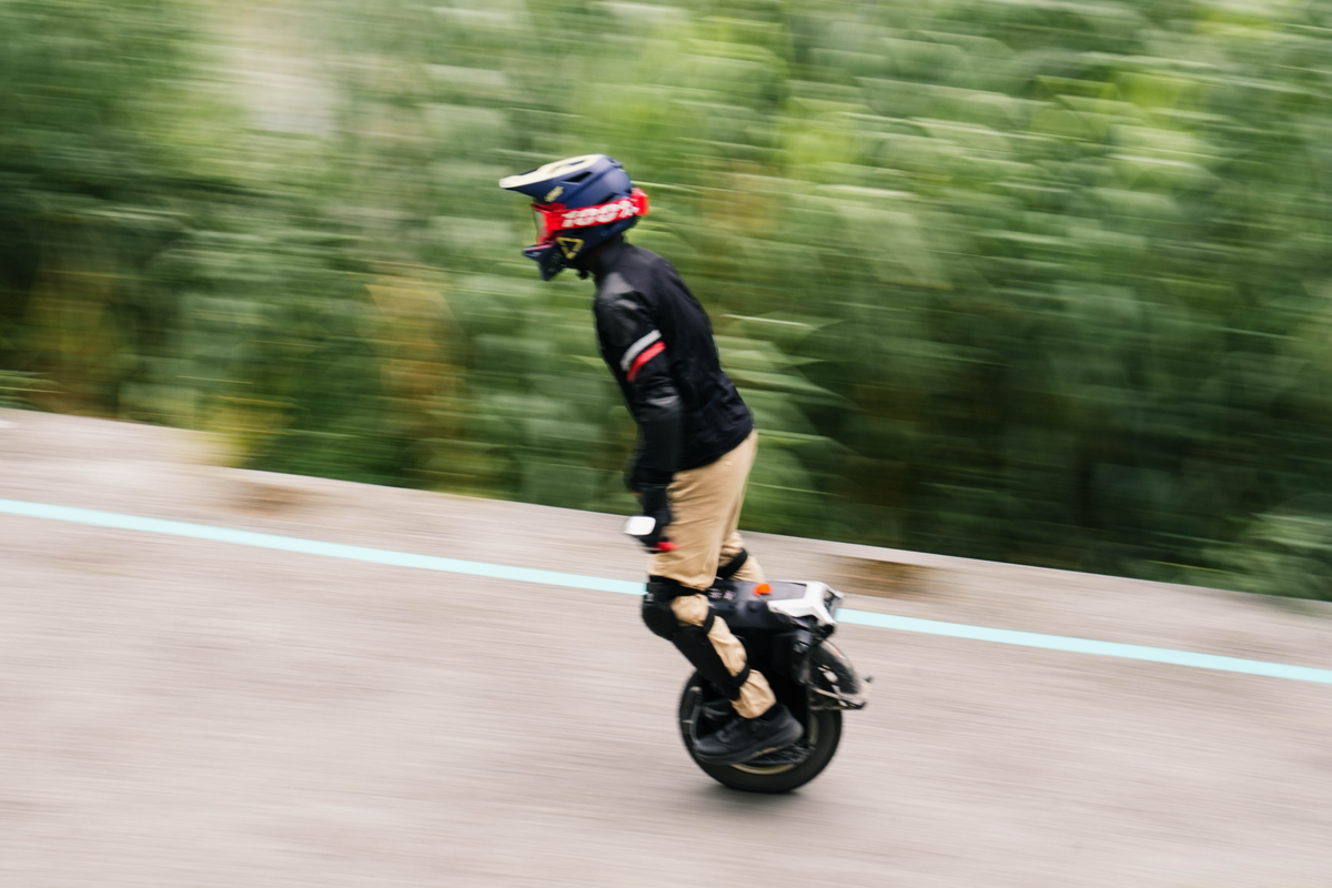 KingSong F16 rider accelerating on a paved path